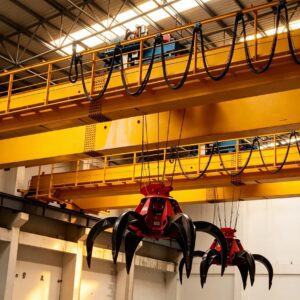 Electric grab overhead crane handling bulk coal in industrial storage yard