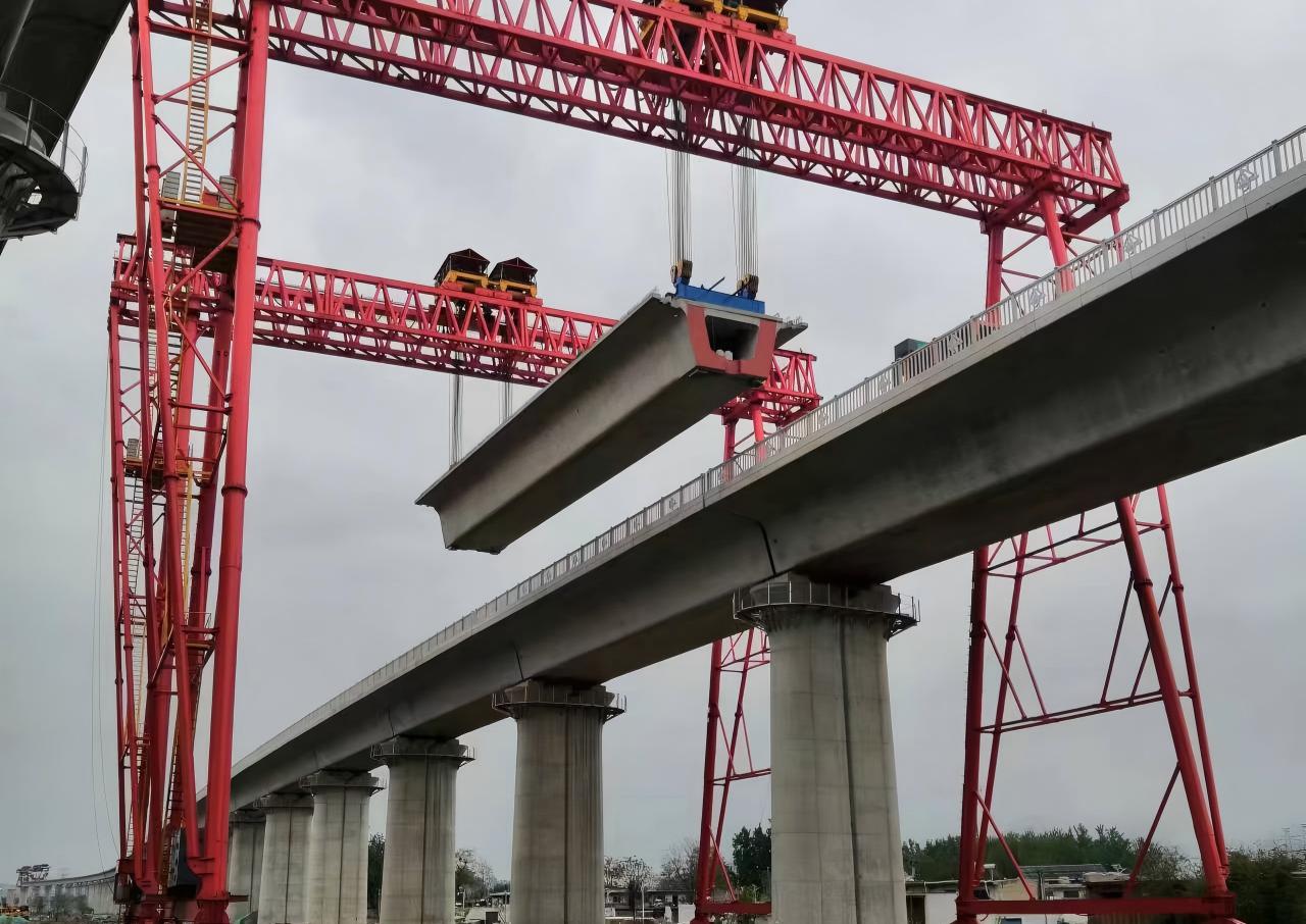 Cranox heavy duty girder lifting gantry crane handling concrete beams in precast yard